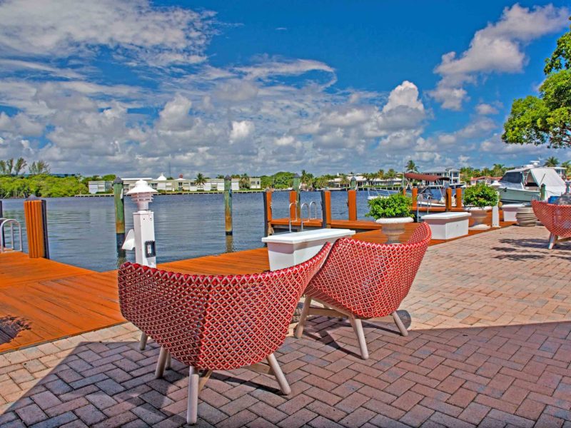 This image exhibits the comfy outdoor lounge with a beautiful waterfront, a perfect place for relaxation with family and friends.